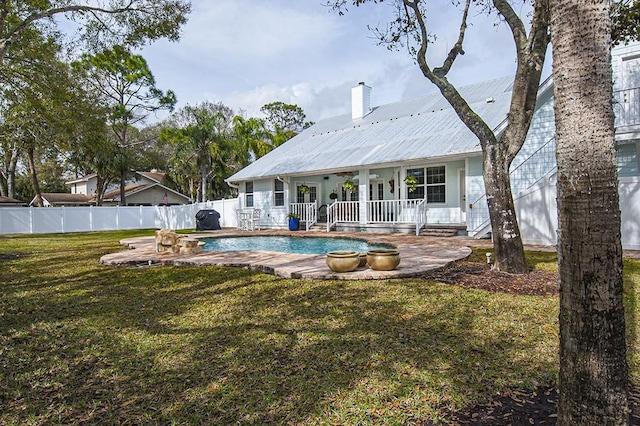 view of swimming pool featuring a patio and a lawn