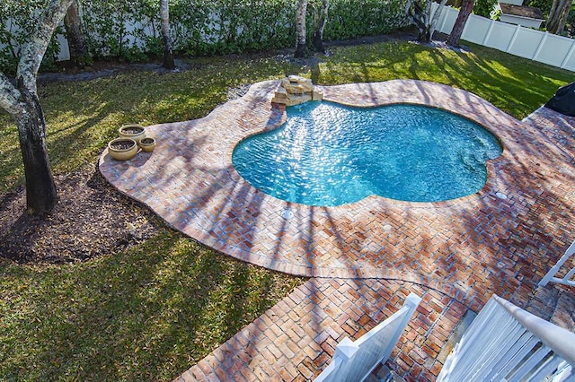 view of swimming pool featuring a patio area and a lawn