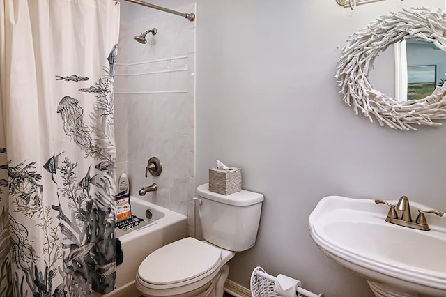 full bathroom featuring sink, toilet, and shower / bath combo with shower curtain