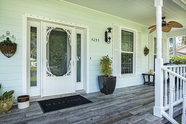 view of exterior entry with ceiling fan