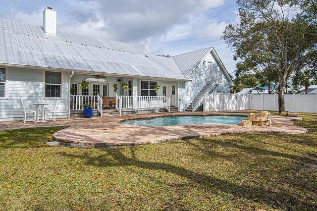 view of pool featuring a lawn and a patio