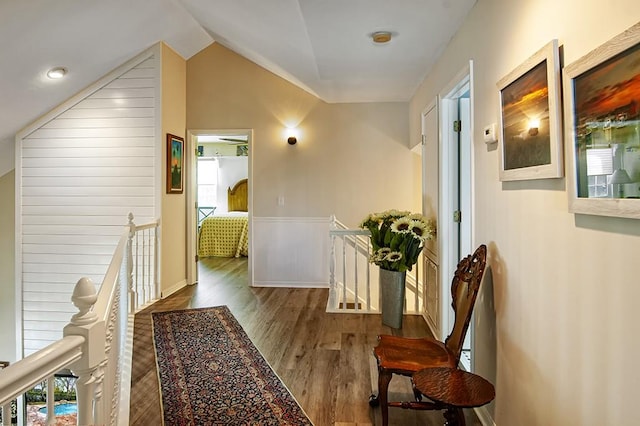 corridor featuring vaulted ceiling and dark wood-type flooring