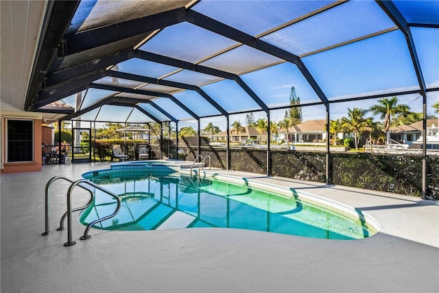 view of pool with an in ground hot tub, a patio, and glass enclosure