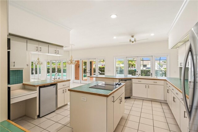 dining space featuring crown molding, a notable chandelier, and light tile patterned floors