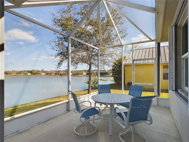 sunroom / solarium featuring a water view