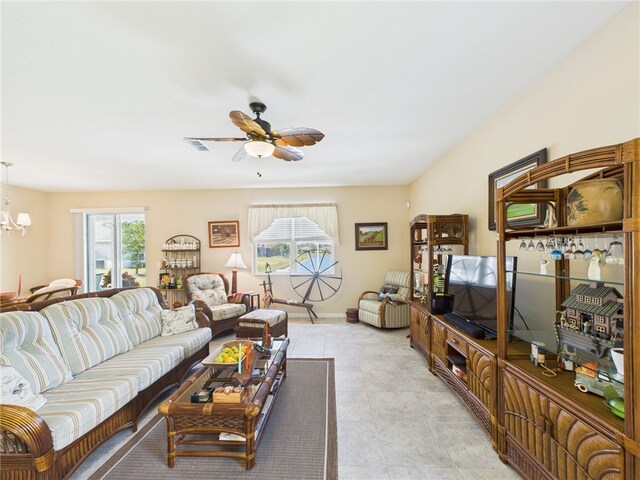living area featuring visible vents, baseboards, and ceiling fan with notable chandelier