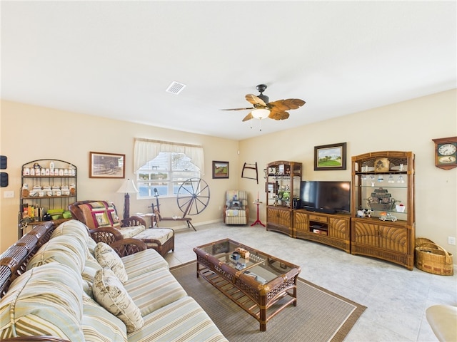 tiled living area featuring baseboards, visible vents, and ceiling fan