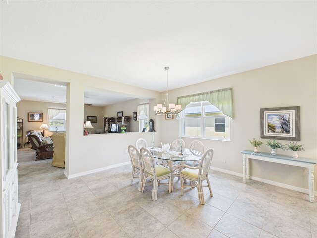 dining space with a chandelier and baseboards