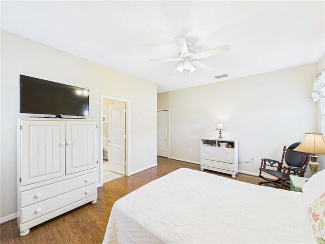 bedroom featuring wood finished floors, a ceiling fan, visible vents, and baseboards