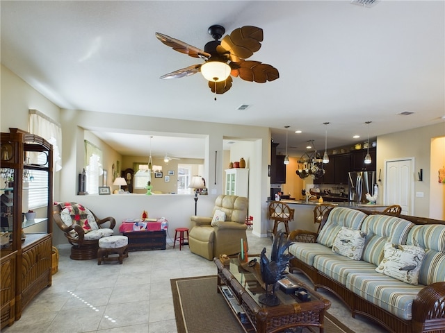 living room featuring plenty of natural light, light tile patterned floors, and ceiling fan