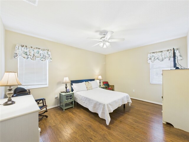 bedroom with visible vents, ceiling fan, wood finished floors, and baseboards