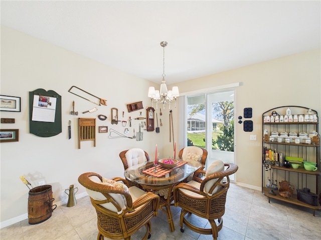 dining area with light tile patterned floors, baseboards, and an inviting chandelier