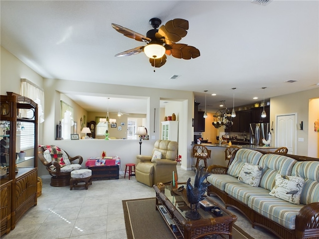 living room with light tile patterned floors, a ceiling fan, and visible vents