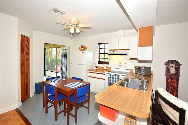 2440 88th Ave, Vero Beach, FL 32966 - kitchen with white appliances, plenty of natural light, a ceiling fan, and extractor fan