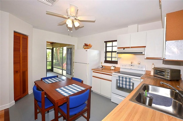 2440 88th Ave, Vero Beach, FL 32966 - kitchen featuring white appliances, range hood, white cabinetry, and a ceiling fan