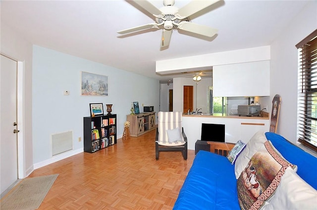 2440 88th Ave, Vero Beach, FL 32966 - living room featuring ceiling fan and baseboards