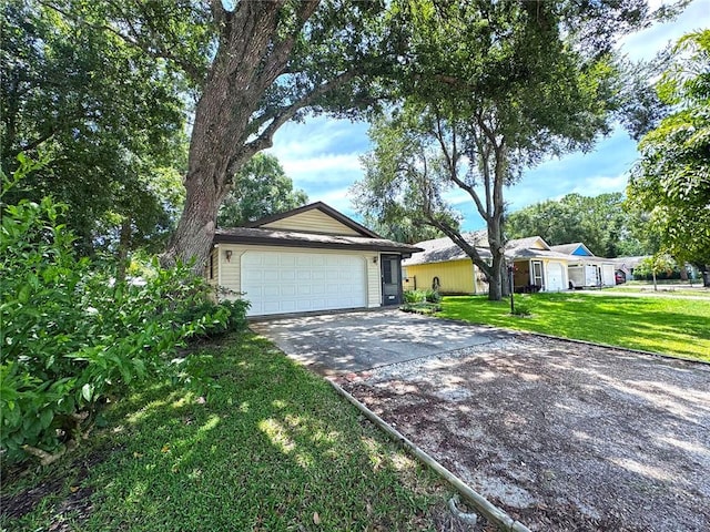 2440 88th Ave, Vero Beach, FL 32966 - ranch-style home with concrete driveway, a front lawn, and a garage