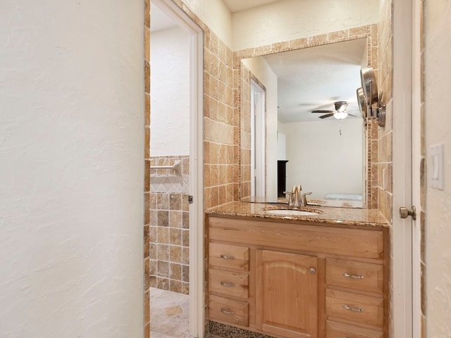 bathroom with vanity, tile walls, and ceiling fan