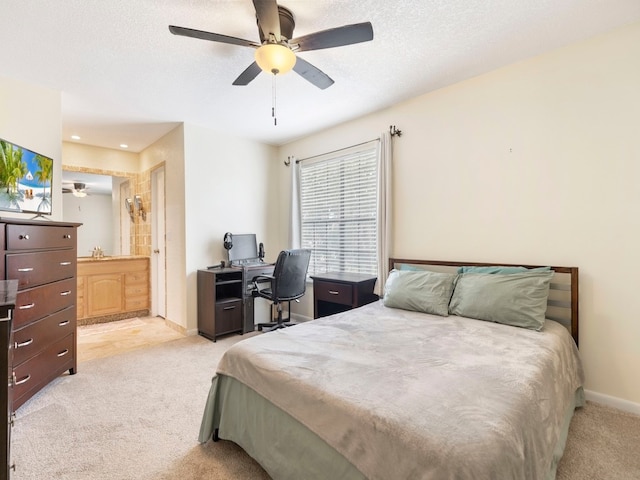 carpeted bedroom with connected bathroom, a textured ceiling, and ceiling fan