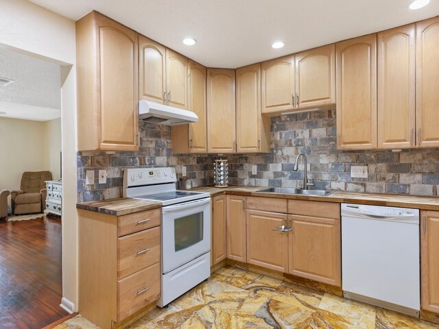 kitchen featuring backsplash, white appliances, sink, and light wood-type flooring