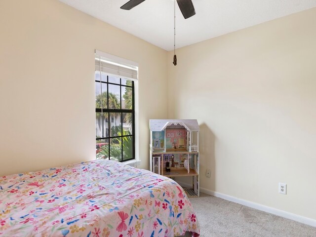 bedroom featuring light colored carpet and ceiling fan