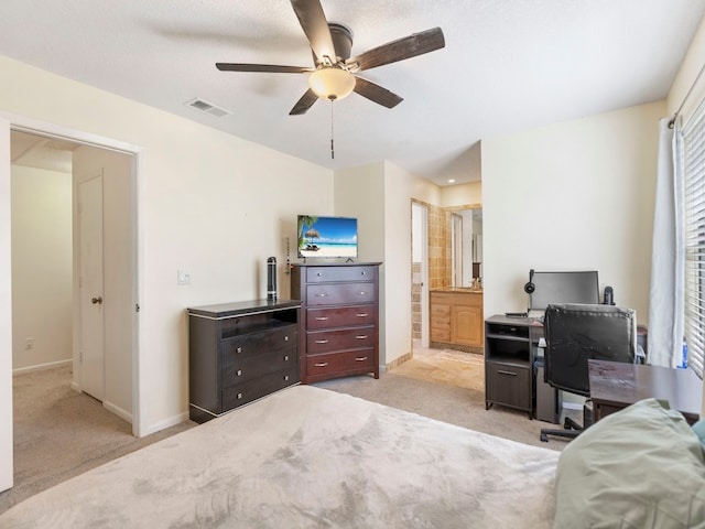 bedroom featuring ensuite bathroom, multiple windows, light carpet, and ceiling fan