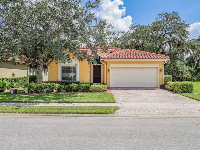 view of front of house with a garage and a front yard