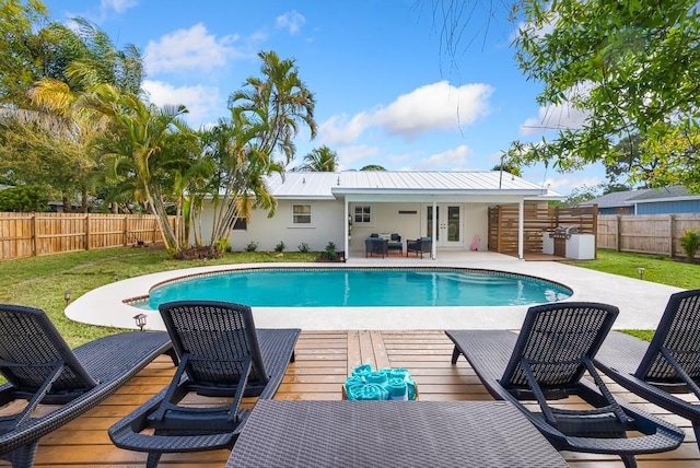 view of pool with french doors, a lawn, a fenced backyard, and a fenced in pool