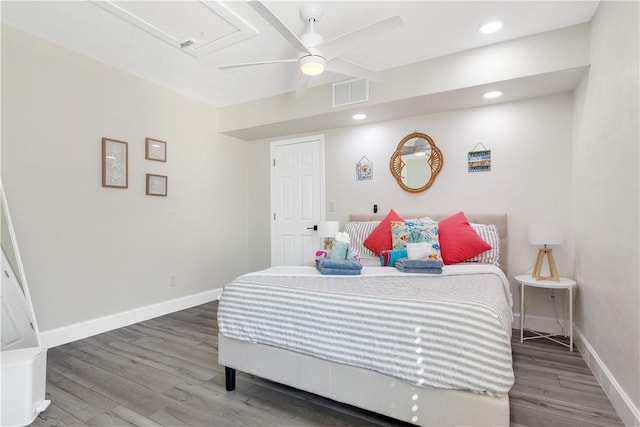 bedroom featuring baseboards, visible vents, wood finished floors, and recessed lighting