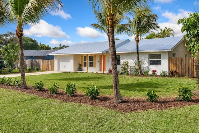 ranch-style house featuring stucco siding, an attached garage, fence, driveway, and a front lawn