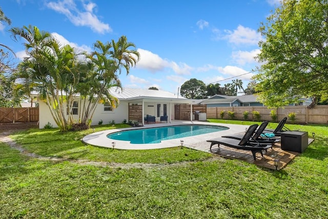 view of swimming pool with a patio, a lawn, a fenced backyard, and a fenced in pool