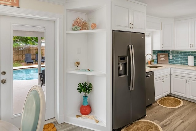 kitchen with stainless steel appliances, white cabinets, light wood-style flooring, and open shelves