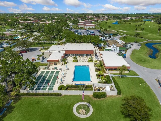 41 Woodland Dr Unit 102, Vero Beach, FL 32962 - drone / aerial view of a nearby body of water, a pool area, and a local golf course
