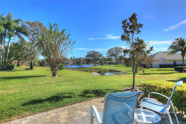 view of yard with a patio area and a water view