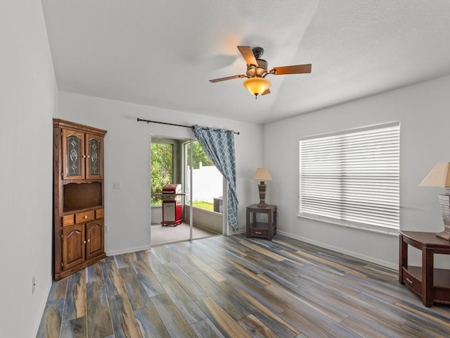 living area featuring hardwood / wood-style flooring and ceiling fan