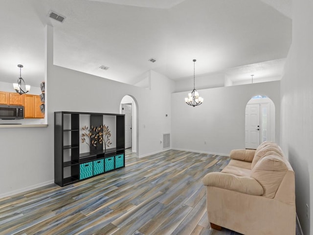 living room featuring hardwood / wood-style floors and a notable chandelier