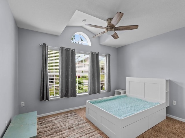 bedroom with carpet flooring, vaulted ceiling, and ceiling fan