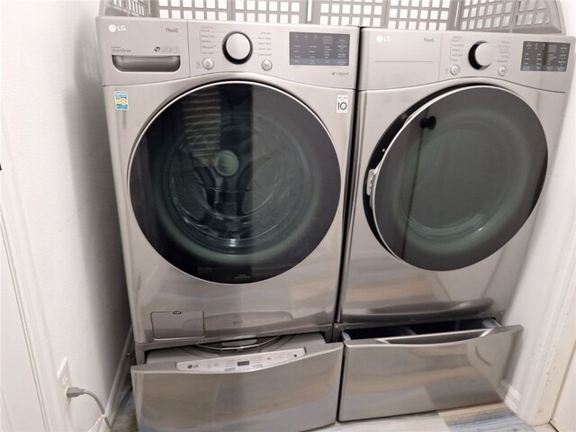 washroom featuring washer and dryer