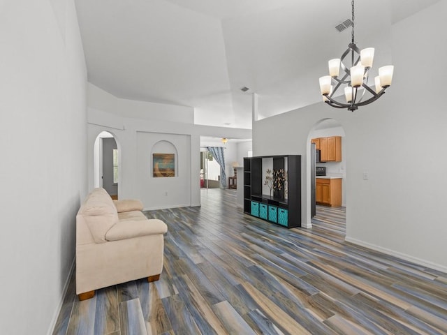 living room featuring an inviting chandelier and dark wood-type flooring