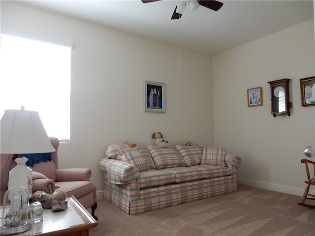 living room with light colored carpet and ceiling fan