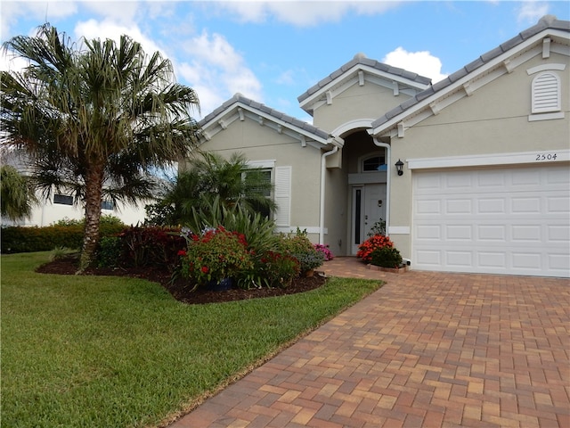 view of front of home with a garage and a front yard