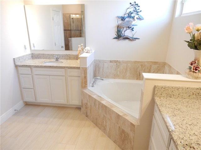 bathroom featuring vanity and separate shower and tub