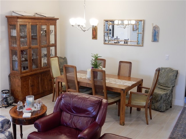 dining area with light tile patterned floors and an inviting chandelier