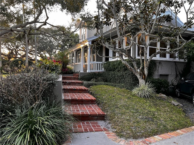 view of side of home featuring a porch