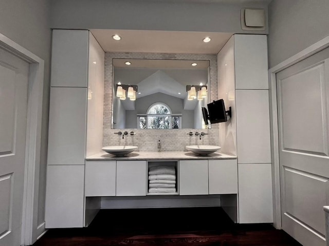 bathroom with vanity and decorative backsplash