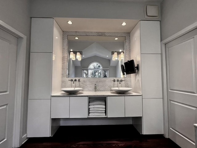 bathroom with tasteful backsplash and vanity