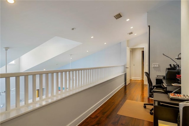 office space featuring vaulted ceiling and dark hardwood / wood-style flooring