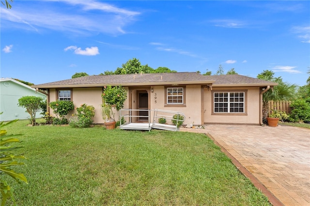 view of front of property with a front lawn and a patio