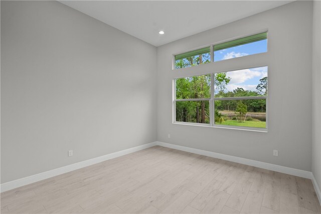 spare room with light hardwood / wood-style flooring