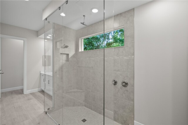 bathroom featuring an enclosed shower and hardwood / wood-style flooring